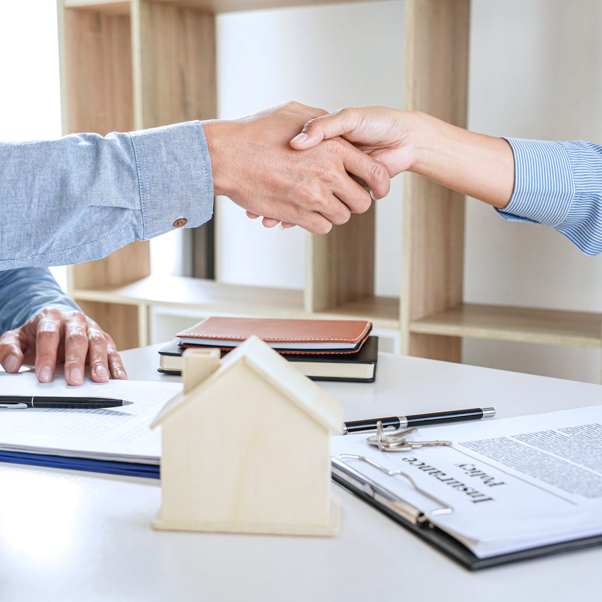 Real Estate Agent and Customer Shaking Hands